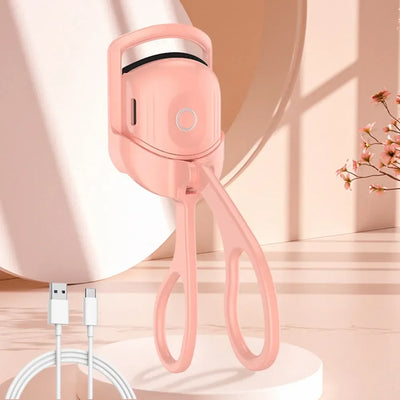 USB Heated Eyelash Curler in pink and white with anti-scald design, shown with before and after lash results for long-lasting curl.